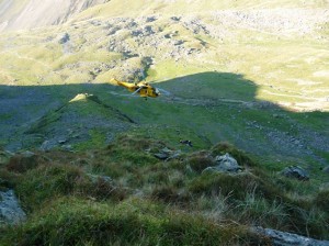 Casualty site is directly above a 500ft drop and in an extremely hazardous area. Hollow Stones in the background. helicopter coming in to drop off the team doctor by winch.