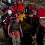 Team members carrying the stretcher through the beck