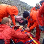 The casualty is strapped into the stretcher for the journey down