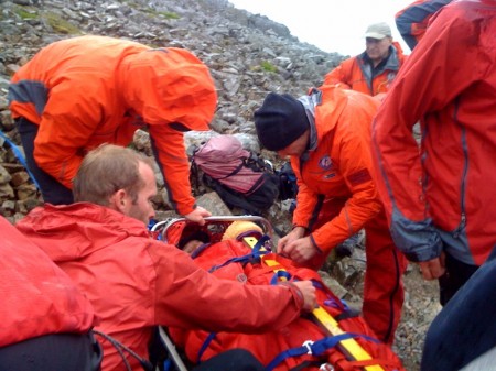 The casualty is strapped into the stretcher for the journey down