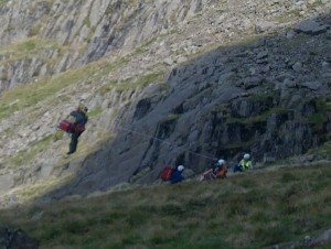 Starting to winch the stretcher containing the casualty accompanied by the winchman