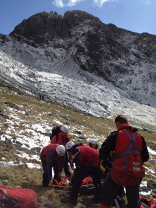 The male casualty being made as comfortable as possible on the stretcher