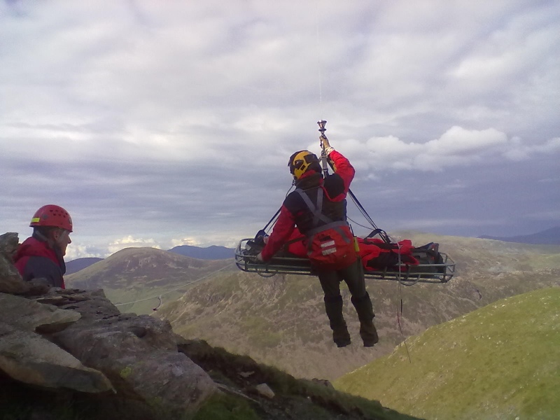 The casualty and winchman being winched into the helicopter